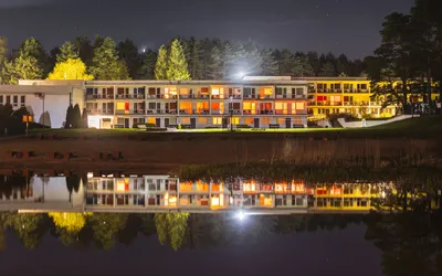 Beautiful night view of a lakeside holiday resort with lights reflecting on the water.