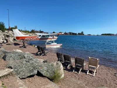 Seaplane docked by Lake Superior with seating on a sunny day in Grand Marais, MN.